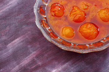 Image showing Glass bowl filled by compote made from red mirabelle plum