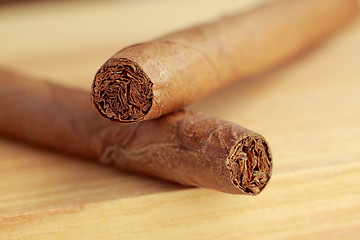 Image showing Cigars on wooden board