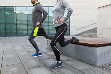 Image showing close up of couple doing lunge exercise on street