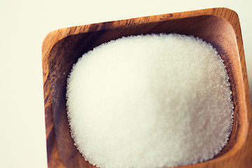 Image showing close up of white sugar heap in wooden bowl