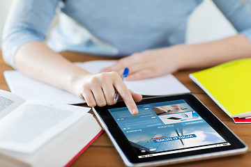 Image showing close up of woman with business news on tablet pc