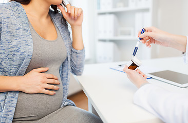 Image showing close up of doctor showing pills to pregnant woman