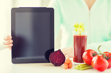 Image showing close up of woman with tablet pc and vegetables