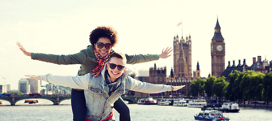 Image showing happy teenage couple having fun over london city