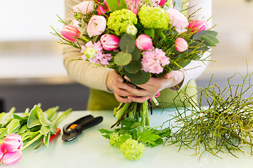 Image showing close up of woman making bunch at flower shop