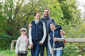 Image showing happy family with backpacks hiking