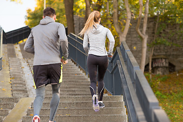 Image showing couple running upstairs in city park