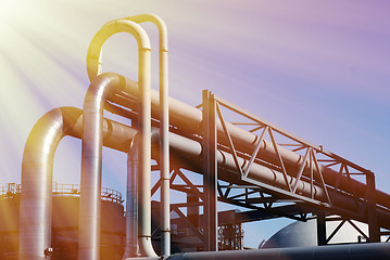 Image showing industrial pipelines on pipe-bridge against blue sky
