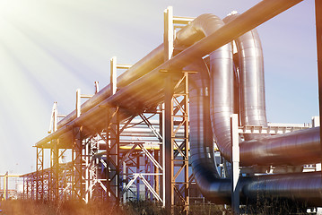 Image showing industrial pipelines on pipe-bridge against blue sky