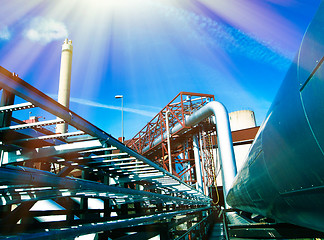 Image showing Industrial zone, Steel pipelines and smokestack on blue sky    