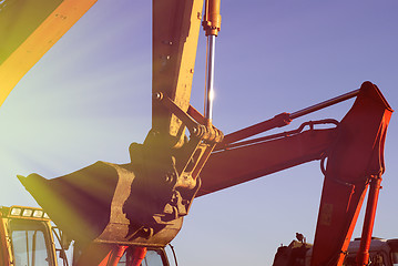 Image showing Hydraulic excavator at work. Shovel bucket against blue sky