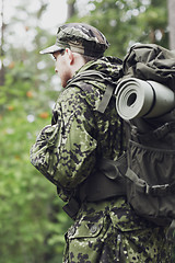 Image showing young soldier with backpack in forest