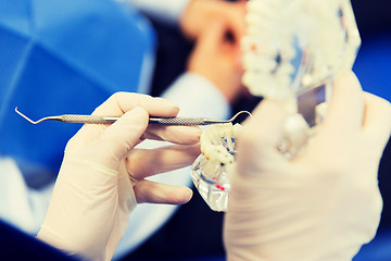 Image showing close up of dentist with teeth and dental probe