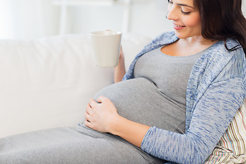 Image showing close up of pregnant woman drinking tea at home