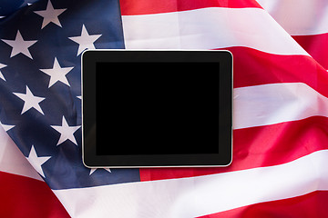 Image showing close up of tablet pc computer on american flag