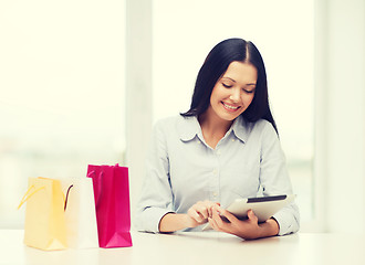 Image showing smiling woman with blank screen tablet pc