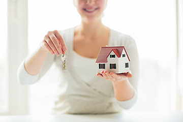 Image showing close up of woman holding house model and keys