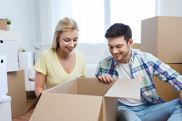 Image showing smiling couple with big boxes moving to new home