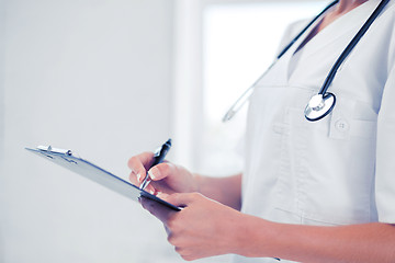 Image showing female doctor with stethoscope and prescription