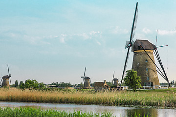 Image showing Traditional Dutch windmills with green grass in the foreground, The Netherlands