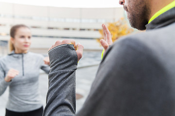 Image showing close up of woman with trainer working strike out