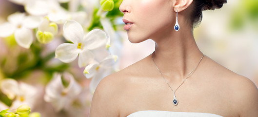 Image showing close up of woman with earring and pendant