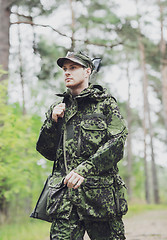 Image showing young soldier or hunter with gun in forest