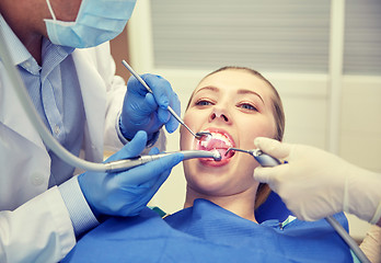 Image showing close up of dentist treating female patient teeth