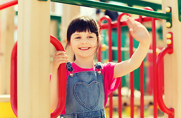 Image showing happy little girl climbing on children playground