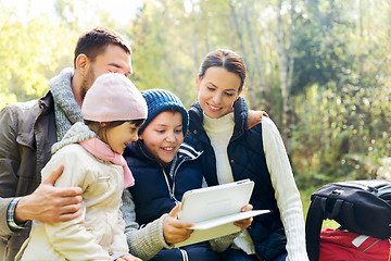 Image showing happy family with tablet pc and backpacks at camp