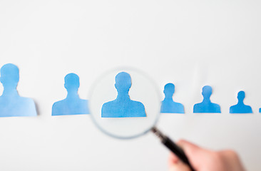 Image showing close up of paper human shapes on white board