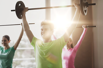 Image showing group of people exercising with barbell in gym