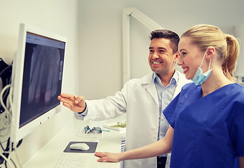 Image showing dentists with x-ray on monitor at dental clinic