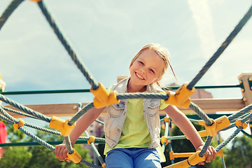 Image showing happy little girl climbing on children playground