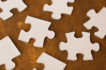 Image showing close up of puzzle pieces on wooden surface