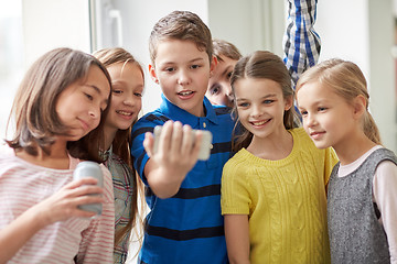 Image showing group of school kids with smartphone and soda cans