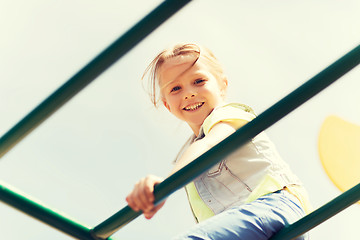 Image showing happy little girl climbing on children playground