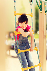 Image showing happy little girl climbing on children playground