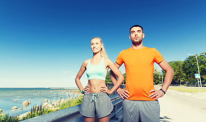 Image showing happy couple exercising at summer seaside