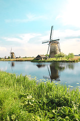 Image showing Traditional Dutch windmills with green grass in the foreground, The Netherlands