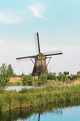 Image showing Traditional Dutch windmills with green grass in the foreground, The Netherlands