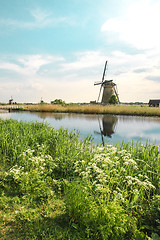 Image showing Traditional Dutch windmills with green grass in the foreground, The Netherlands