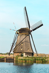 Image showing Traditional Dutch windmills with green grass in the foreground, The Netherlands