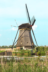 Image showing Traditional Dutch windmills with green grass in the foreground, The Netherlands