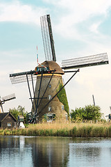 Image showing Traditional Dutch windmills with green grass in the foreground, The Netherlands