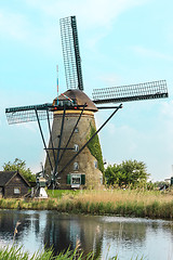 Image showing Traditional Dutch windmills with green grass in the foreground, The Netherlands