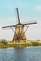 Image showing Traditional Dutch windmills with green grass in the foreground, The Netherlands