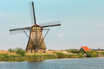 Image showing Traditional Dutch windmills with green grass in the foreground, The Netherlands