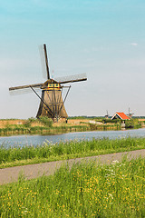 Image showing Traditional Dutch windmills with green grass in the foreground, The Netherlands