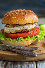 Image showing Burger with chicken, hot sauce and salad.